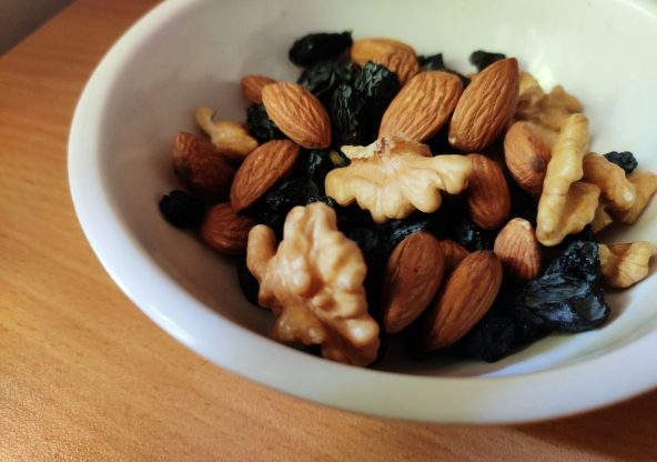 brown and black nuts on white ceramic bowl