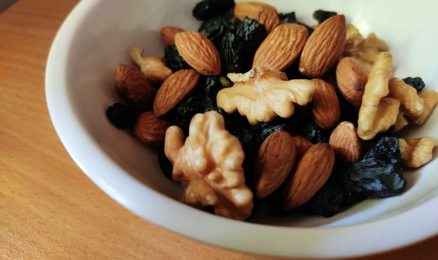 brown and black nuts on white ceramic bowl