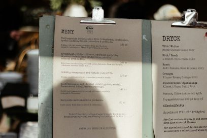 A menu sitting on top of a table next to a cup of coffee